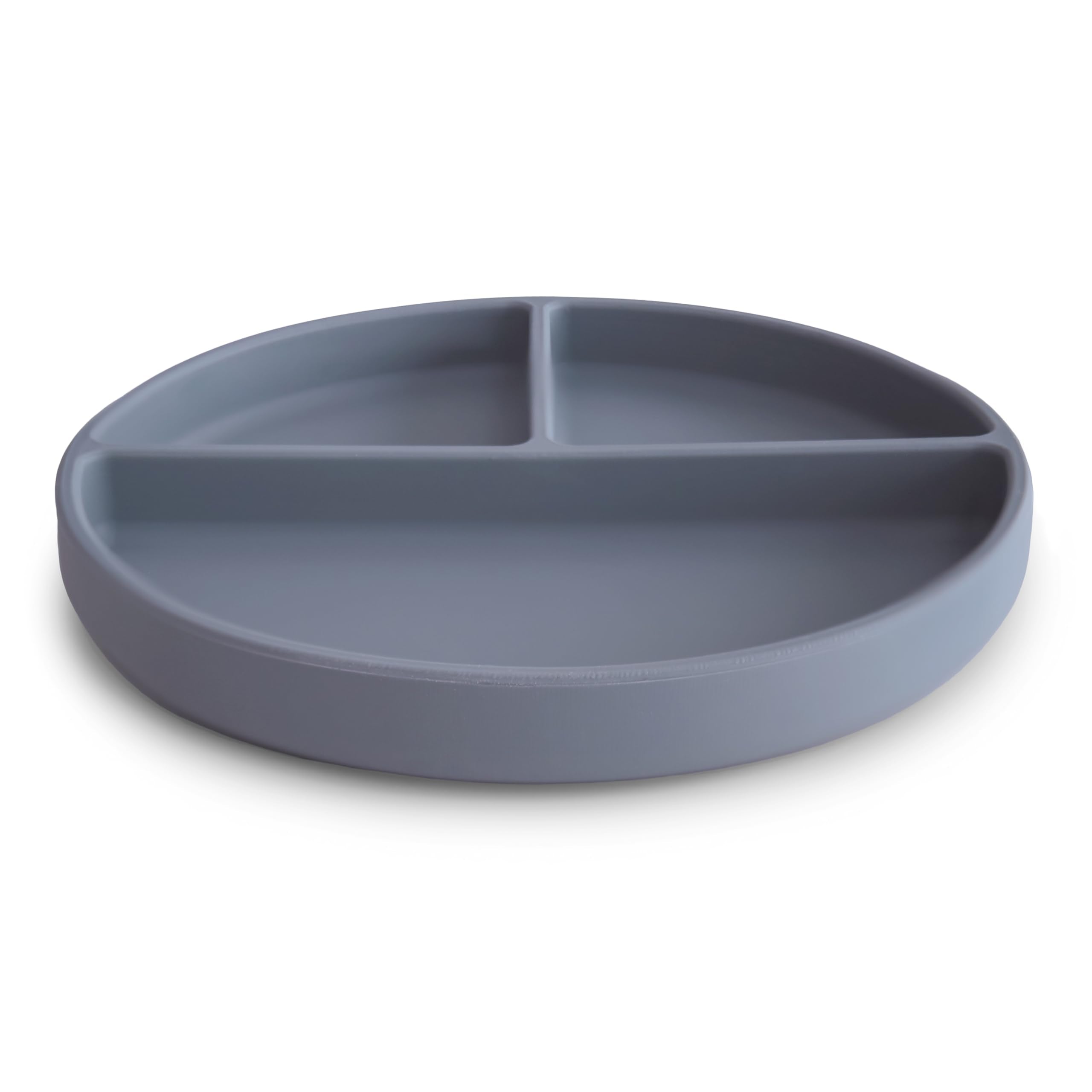Mushie suction plate in use with child demonstrates self-feeding stability