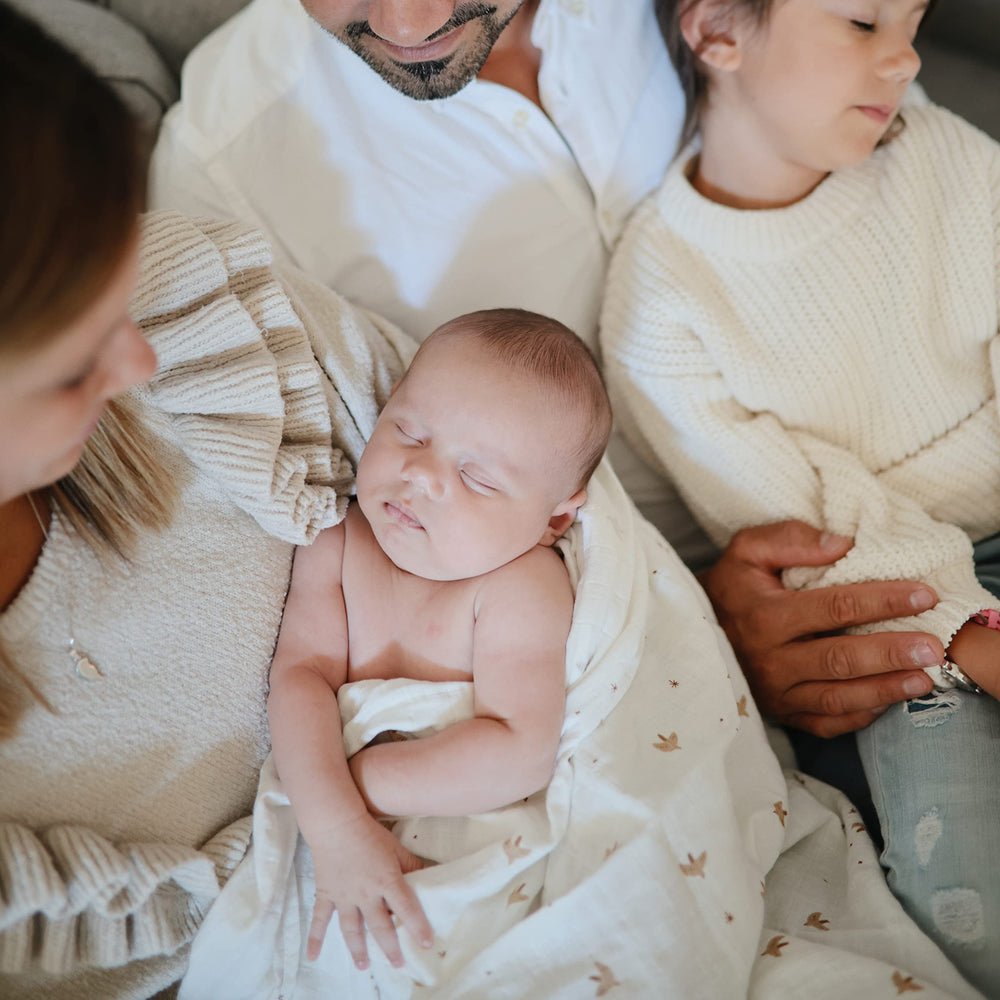 Mushie Sparrow muslin swaddle measures 47x47 inches for versatile wrapping.