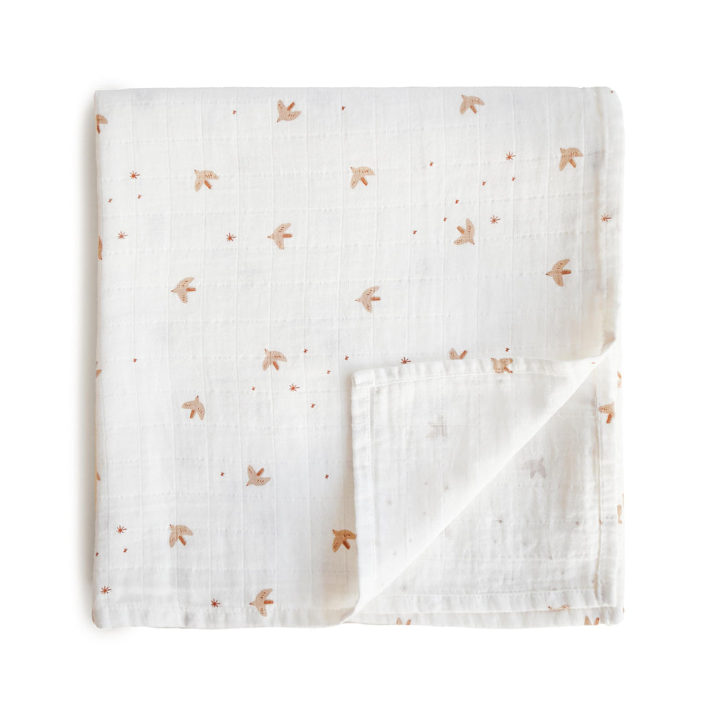Mushie Sparrow muslin swaddle blanket with soft, breathable fabric for peaceful baby naps.