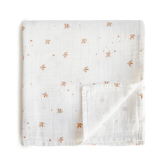 Mushie Sparrow muslin swaddle blanket with soft, breathable fabric for peaceful baby naps.