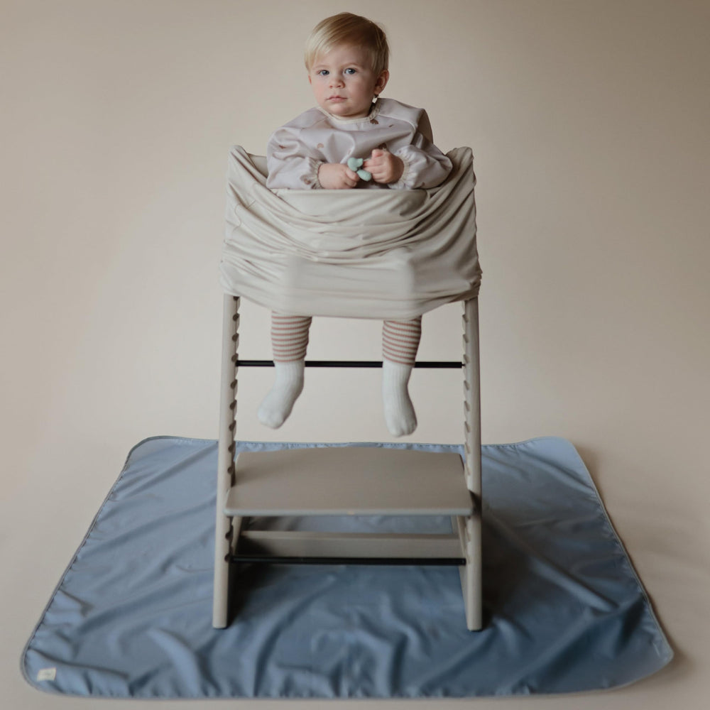 Mushie Splat Mat protects tables during arts and crafts