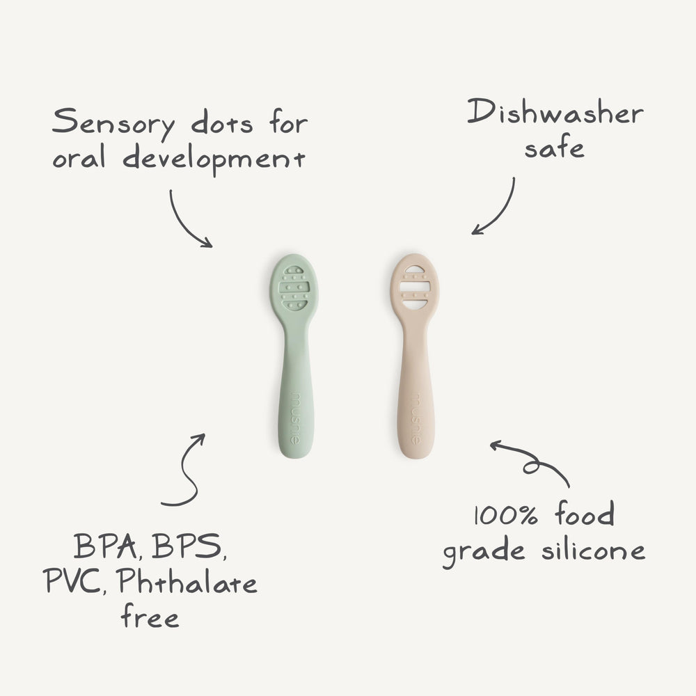 Mushie stage-2 spoon with open slots helps scoop thicker foods confidently.