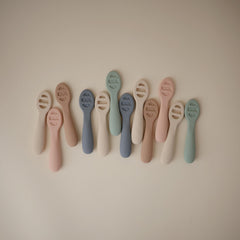 Stage 2 Mushie spoon with open slots ideal for thicker textures.