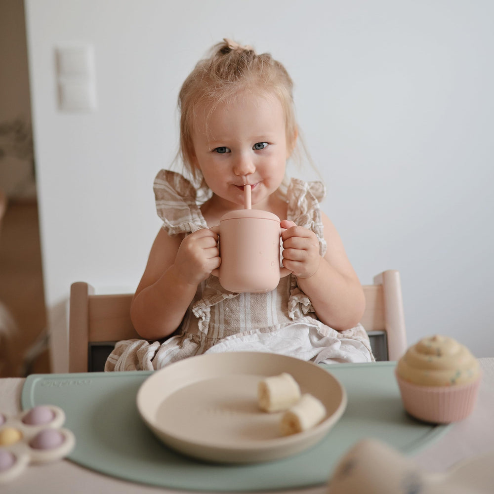 Mushie silicone straw promotes gentle sipping for teething and early drink training.