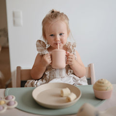 Mushie silicone straw promotes gentle sipping for teething and early drink training.