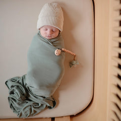 Mushie Stretchy Mini Crib Sheet on mattress demonstrates 24x38 fit