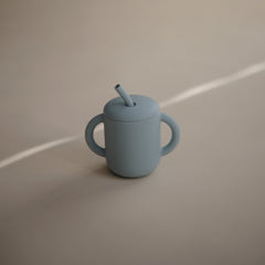 Close-up of Mushie training cup lid preventing spills.