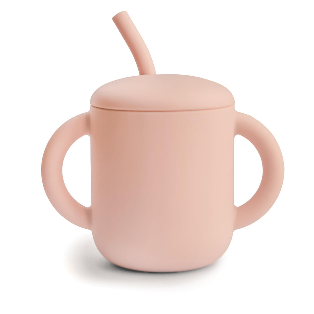 Mushie training cup with lid, blush color, helping prevent spills during meals.