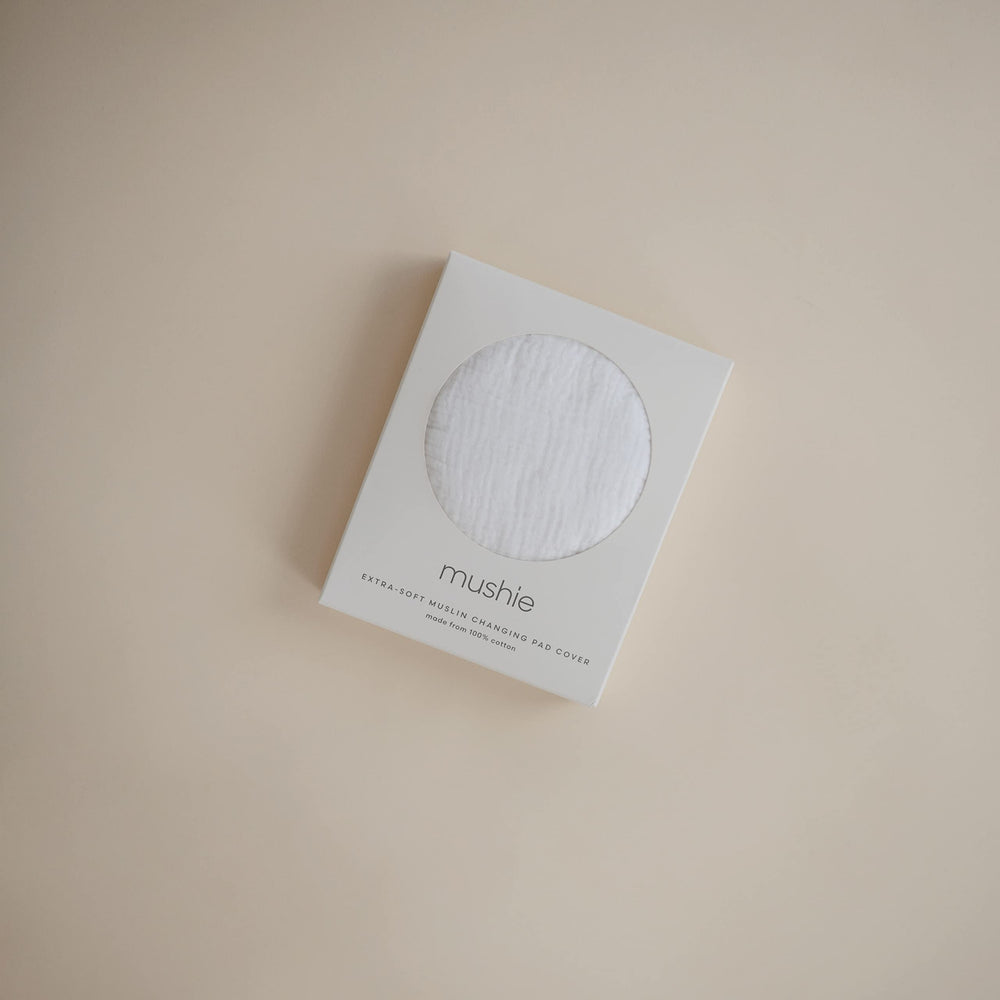 Mushie cover with two holes for belt access supports safe diaper changes