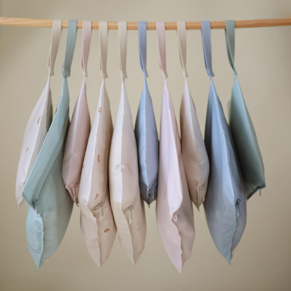 Mushie blue-check wet bag set offering versatile storage options.