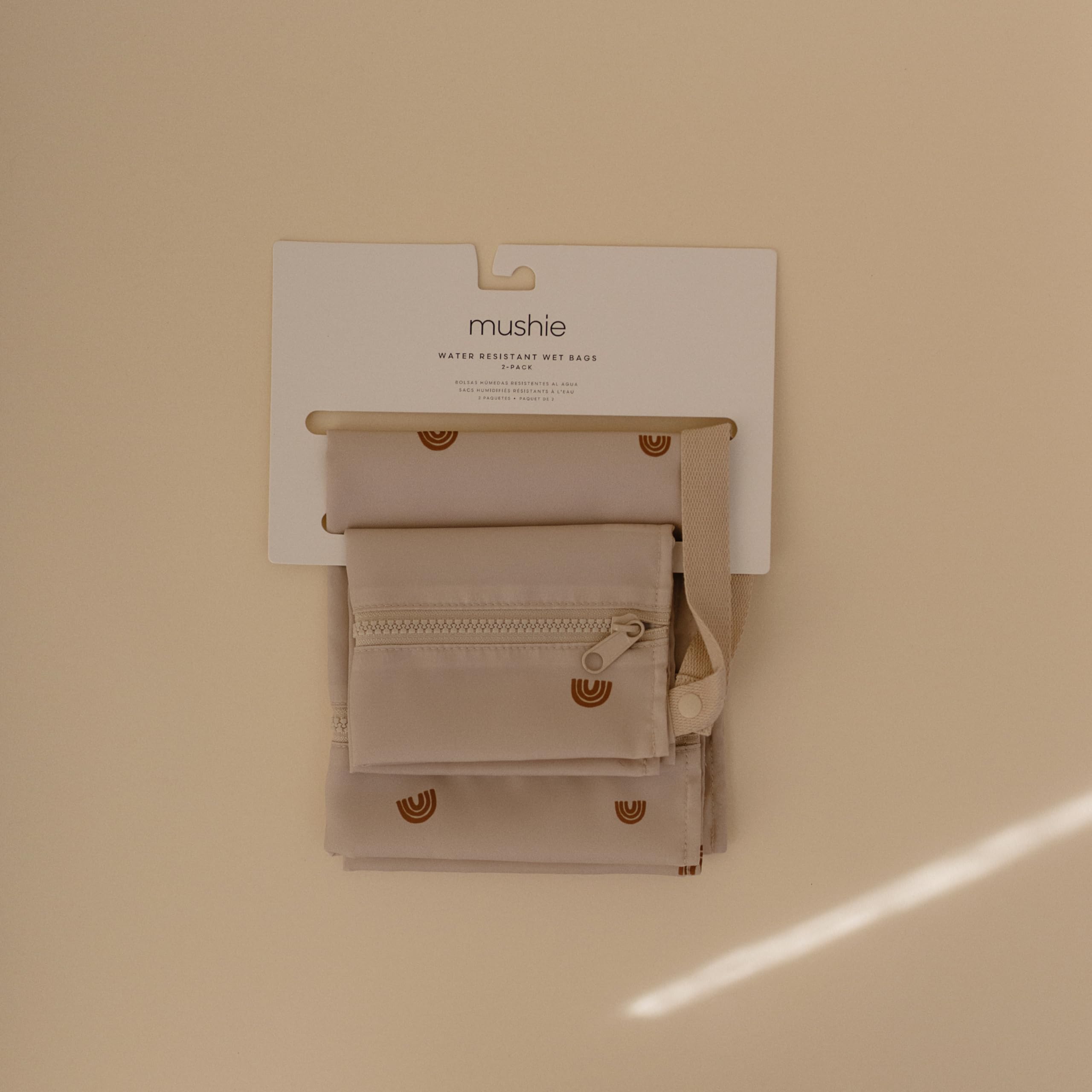 Mushie wet bags with zipper closure securely hold items on trips.