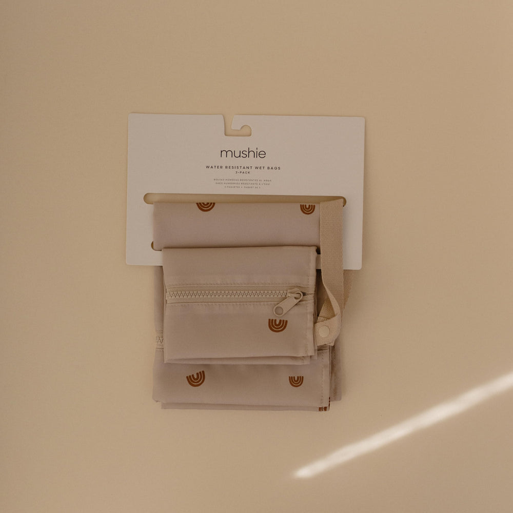 Mushie wet bags with zipper closure securely hold items on trips.