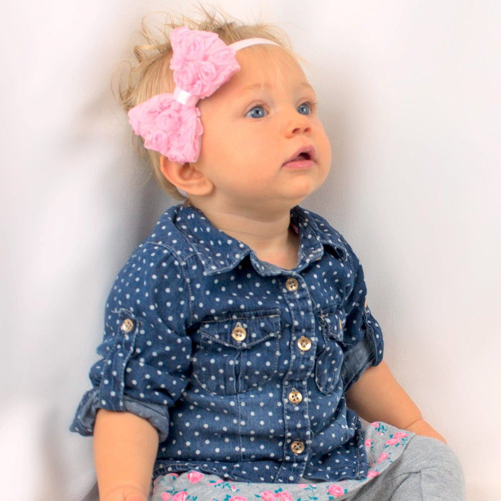 Close up of My Lello fabric rose bows on newborn headbands for gentle styling