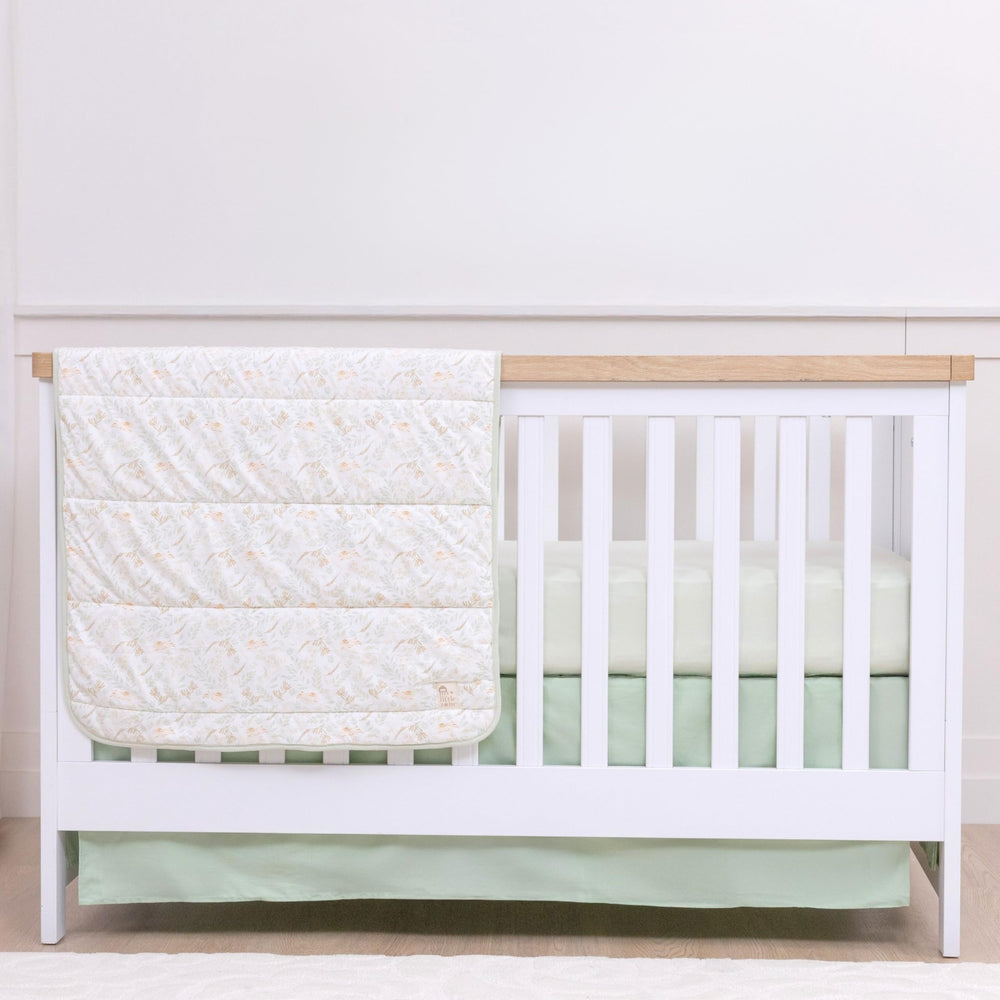 My Little Zone green crib skirt 52x28 on a standard crib hides storage space and adds woodland charm.