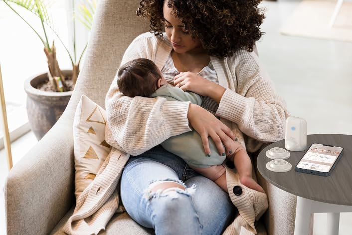 New mom using MyLee companion app during night nursing.