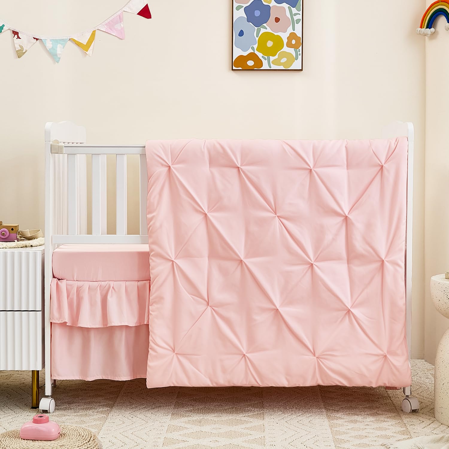 NacoMoco pink crib skirt completes the set with a clean nursery look