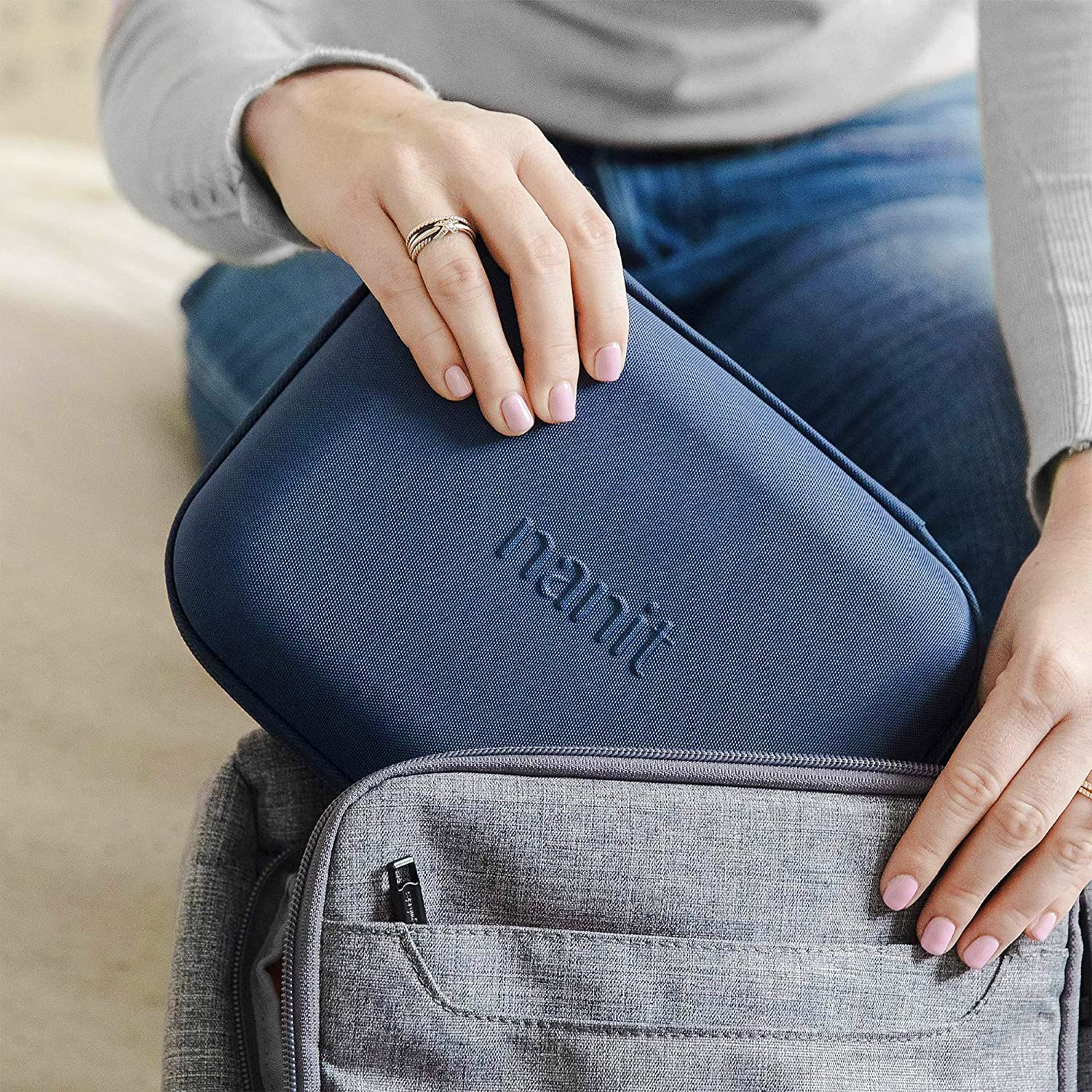 Nanit Travel Pack shown in a diaper bag setup for travel-ready protection.