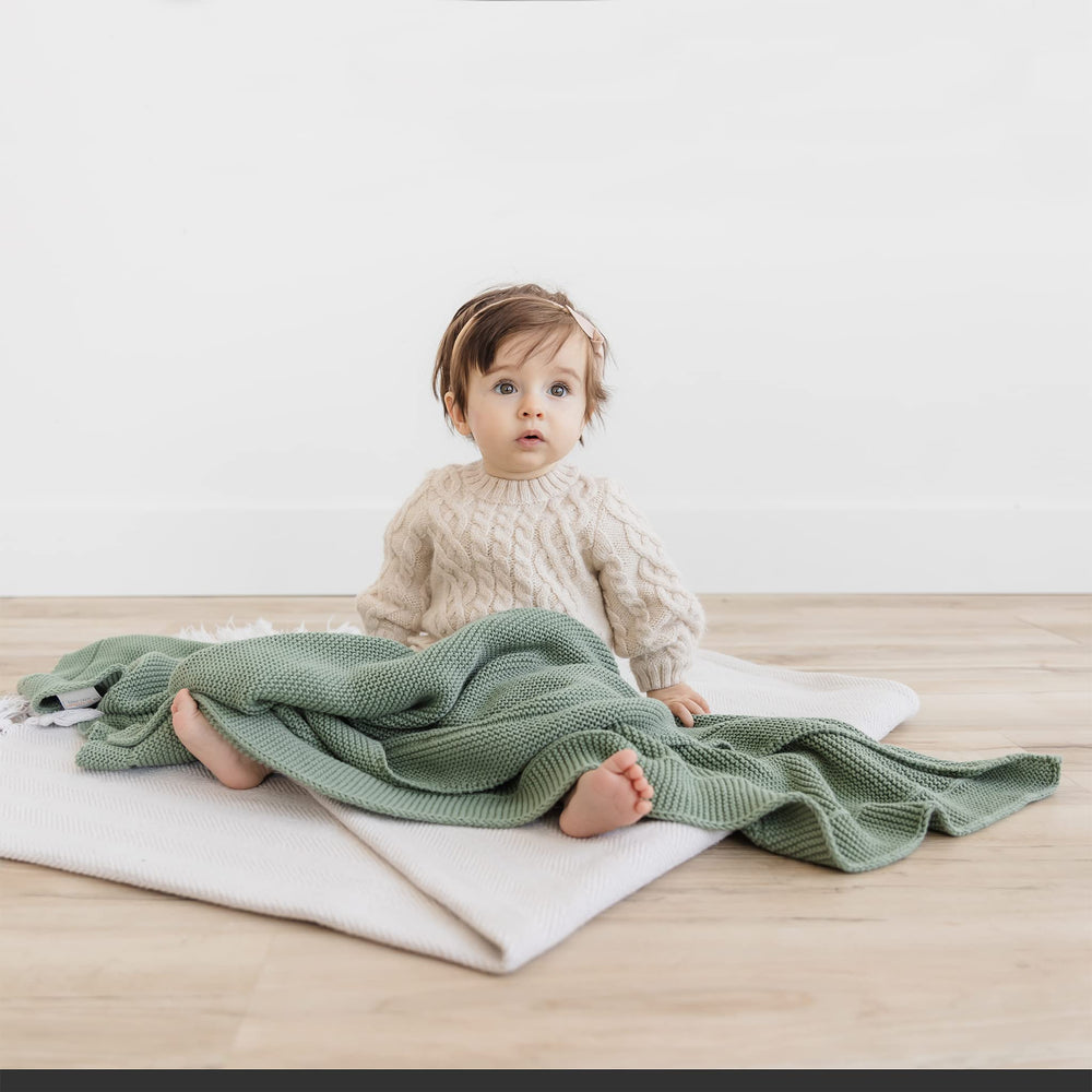 Natemia blanket used as stroller cover to shield from sun.