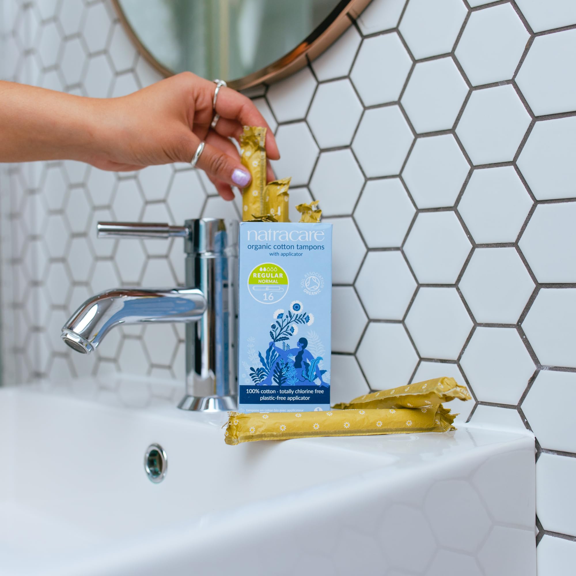 Natracare tampons on a bathroom shelf, highlighting plastic-free, chlorine-free design.