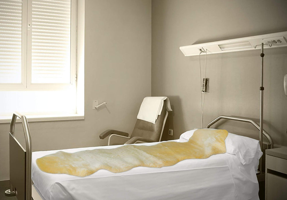 Natural Design N natural sheepskin mattress pad 24x36 smooths pressure and improves airflow.