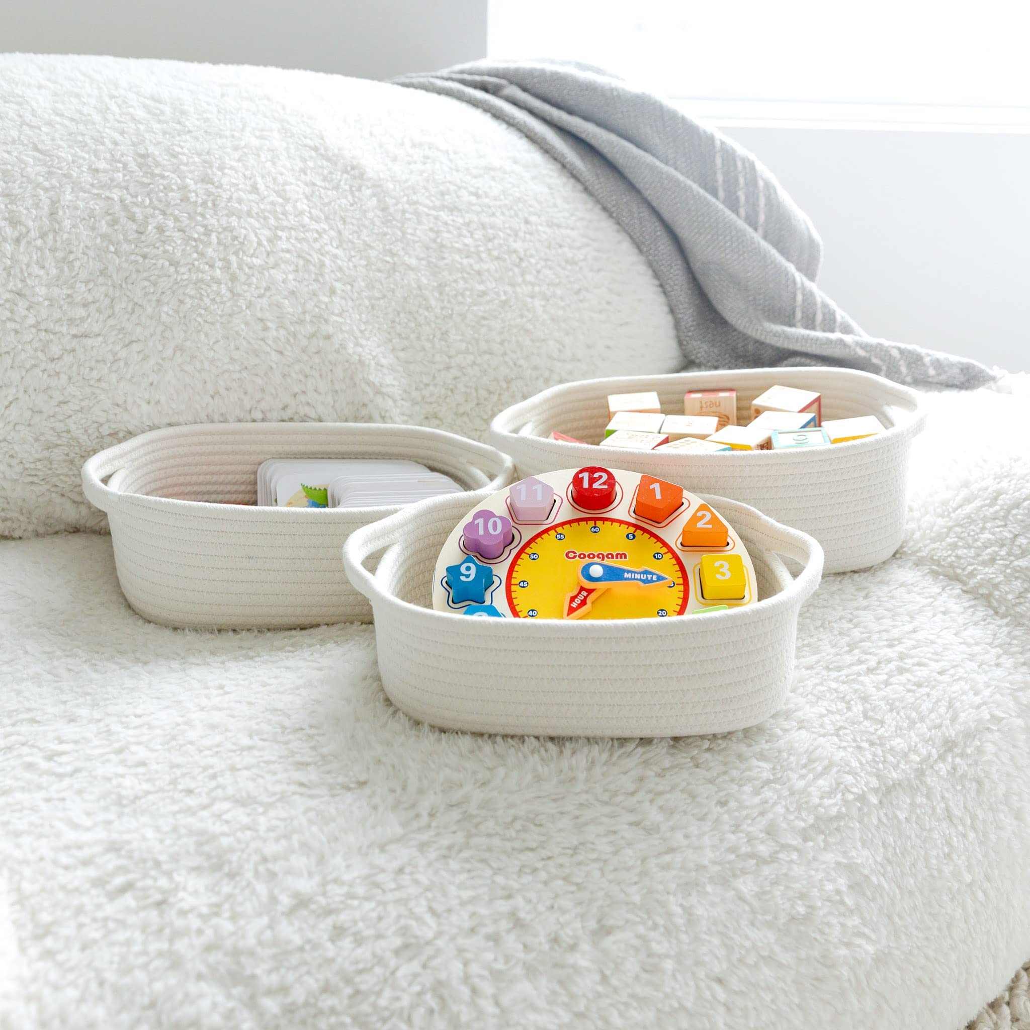 NaturalCozy bathroom organization basket grouping towels and toiletries.