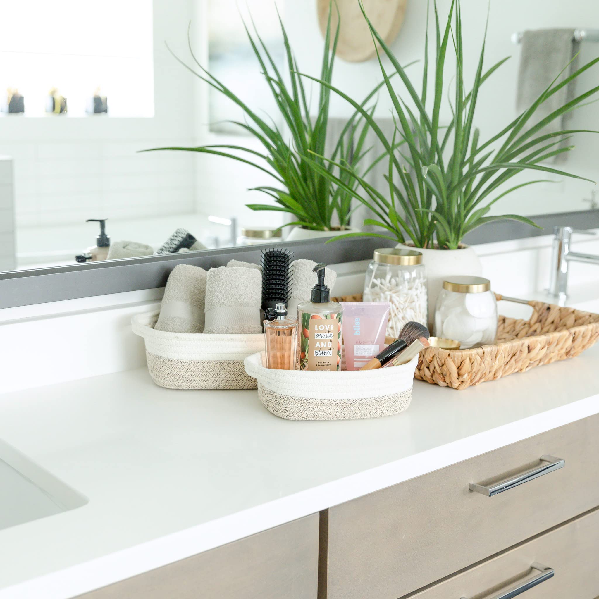 NaturalCozy rectangle basket set bathroom organizer to tidy towels and toiletries.