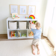 NaturalCozy square storage bins on a shelf offering roomy toy and blanket storage.
