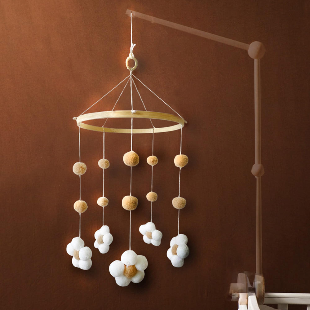 Nerdichic daisy flower mobile on wood hoop ideal for soothing newborns in a neutral nursery.