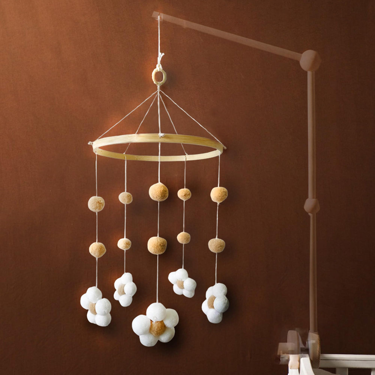 Nerdichic daisy flower mobile on wood hoop ideal for soothing newborns in a neutral nursery.