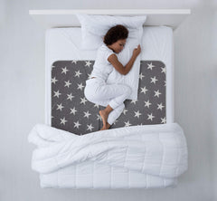 NEUMA DESIGN bed pad waterproof cover in use on a bed for mattress protection