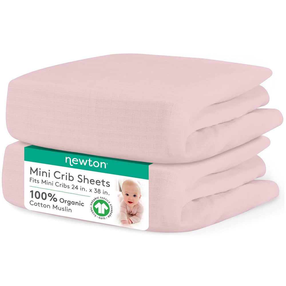 Newton Baby fitted mini crib sheet Sunrise Pink on mattress—breathable, snug mini-crib fit.