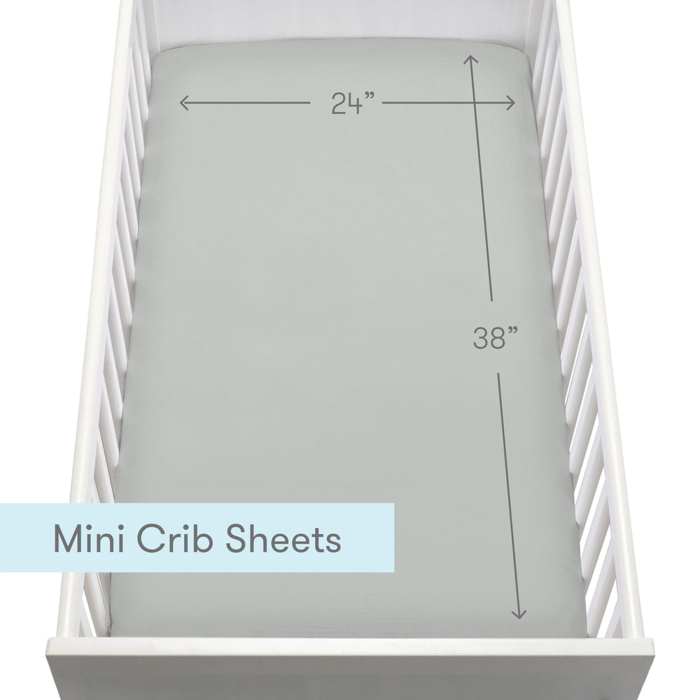 Newton Baby machine-washable crib sheets photo highlights easy cleaning and quick dryer-ready cycles.