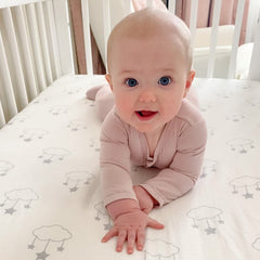 Newton Baby star-pattern sheet in white, soft muslin fabric for gentle baby sleep.