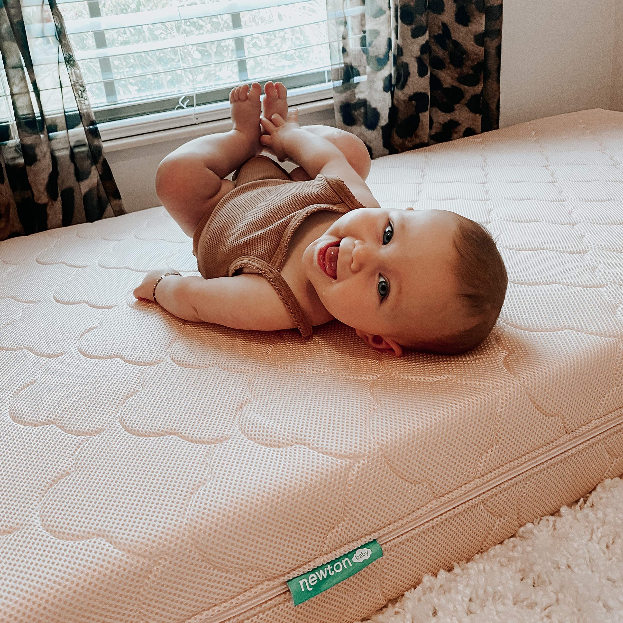 Newton Baby Waterproof Extra Cover is machine washable for busy parents.
