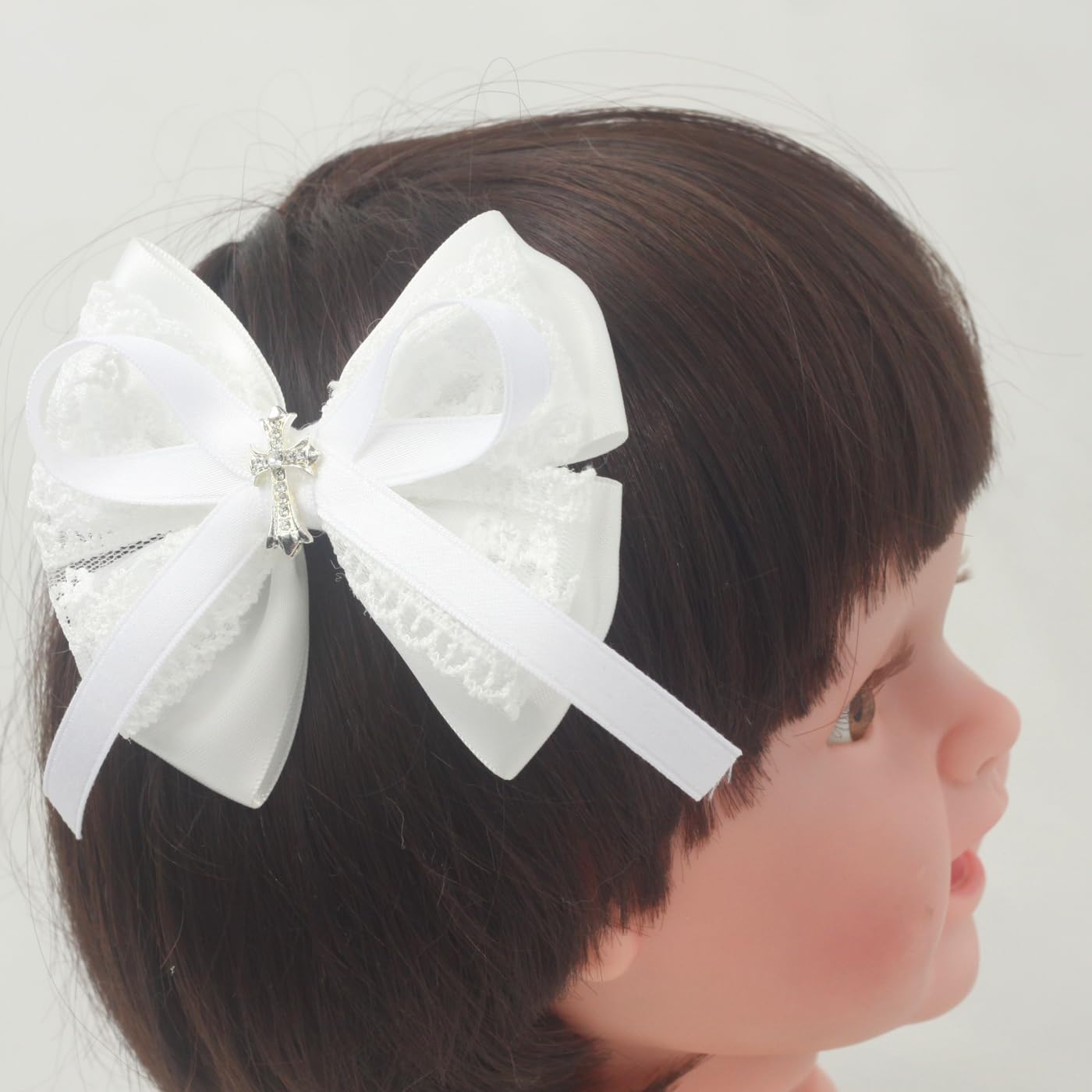 Nihao Baby cross bow detail highlighting delicate stitching.