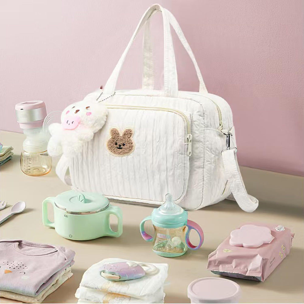 NIKUKY diaper bag with cute cartoon pattern adds style to outings.