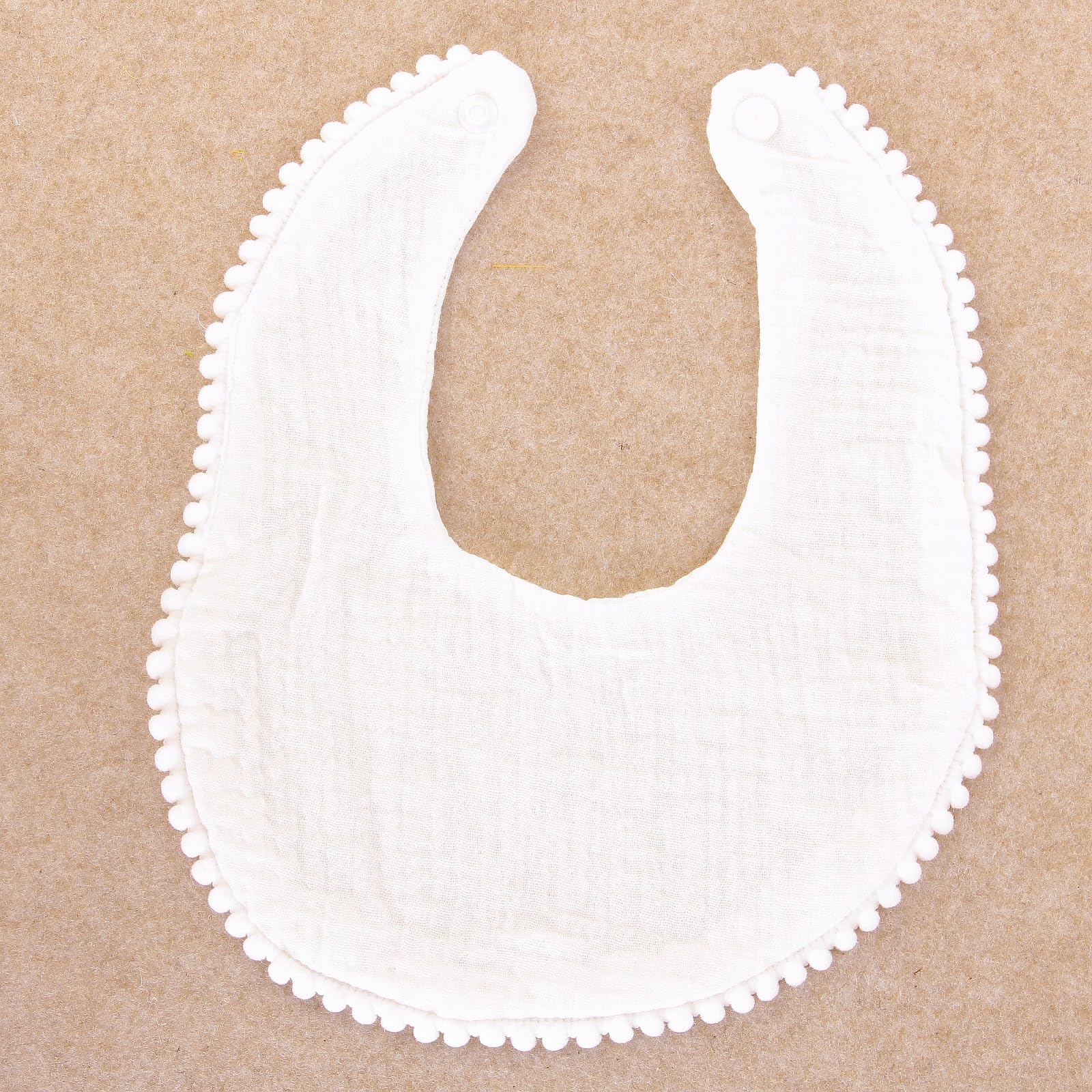 Nishine bib snap closure demonstrates easy on/off during meals