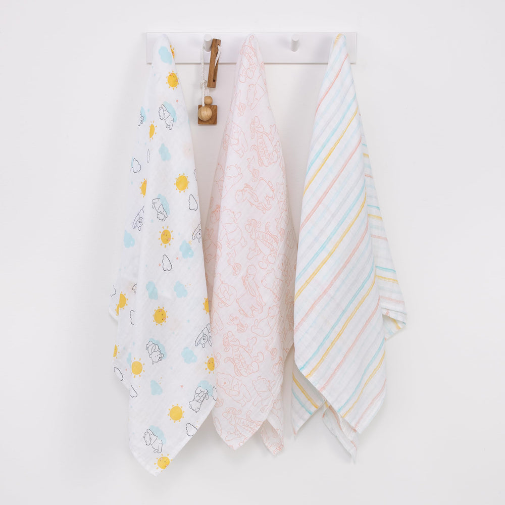 NoJo Pooh and friends swaddle captures playful nursery moments with soft cotton.