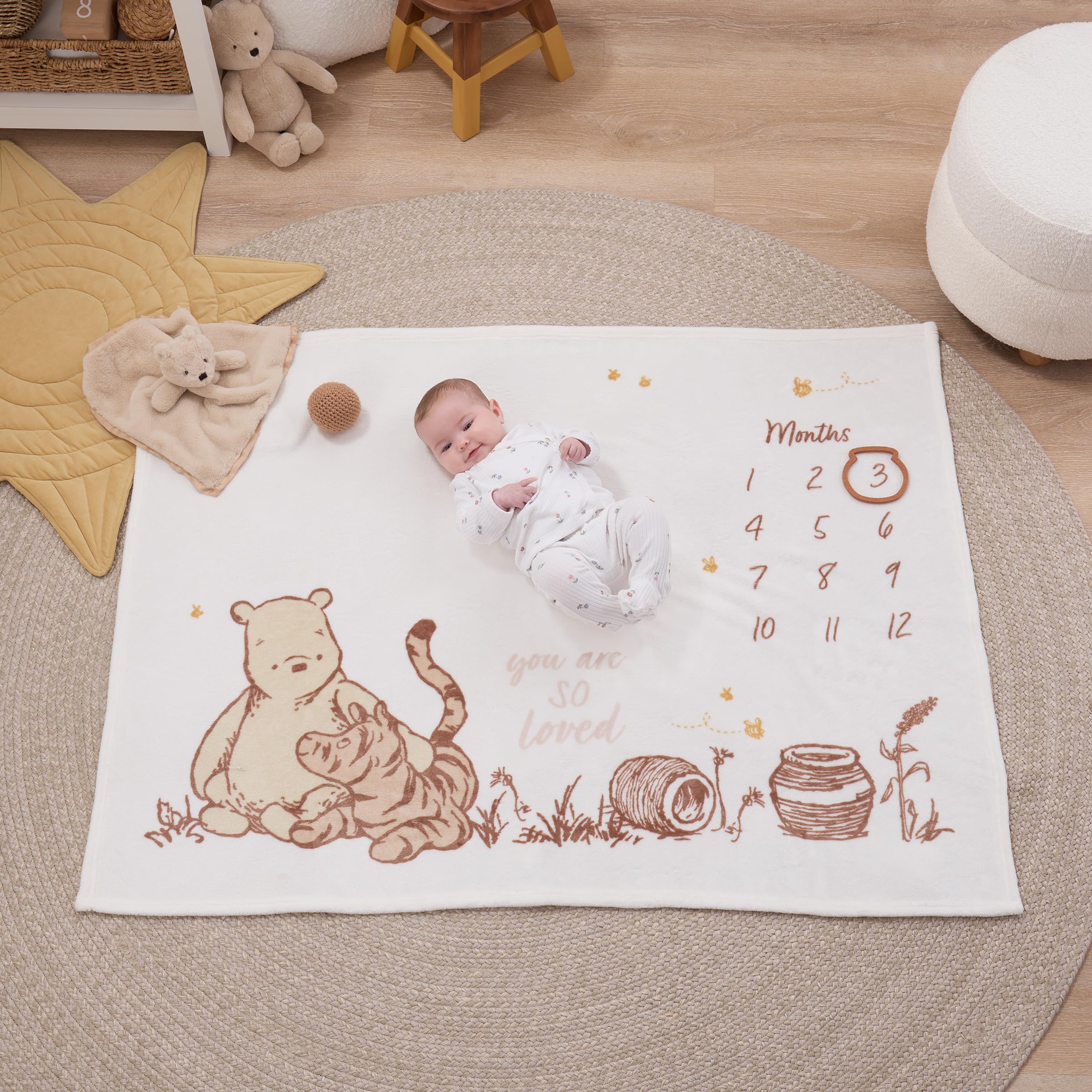 NoJo Winnie the Pooh blanket features ivory taupe tones for timeless nursery decor