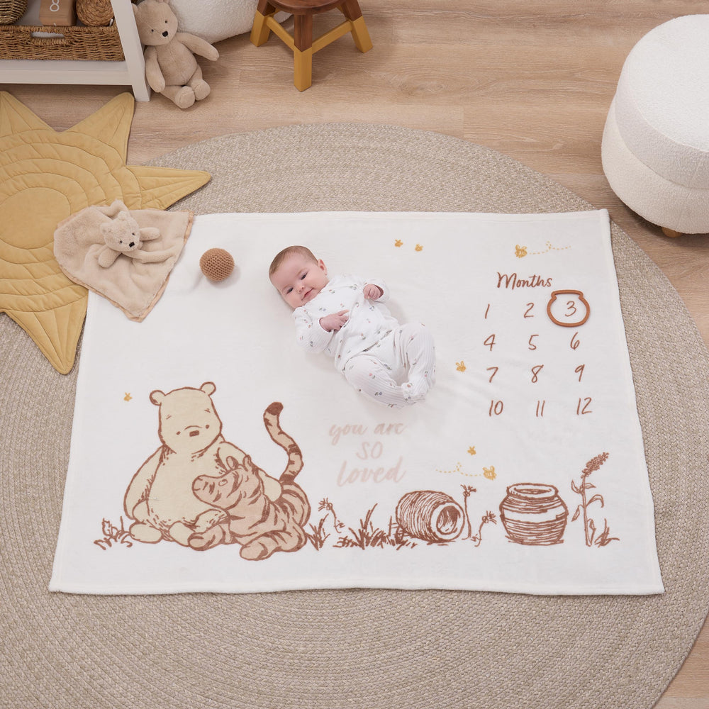 NoJo Winnie the Pooh blanket features ivory taupe tones for timeless nursery decor