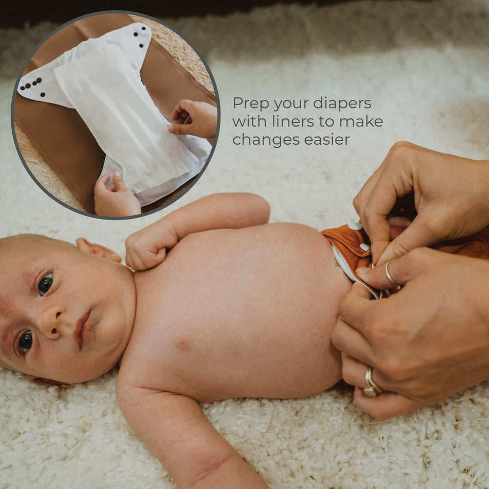 Nora's Nursery liner in use during a diaper change, aiding quick changes