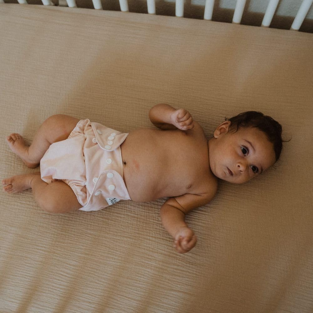 Nora's Nursery stylish prints and earth-toned designs for baby outfits.