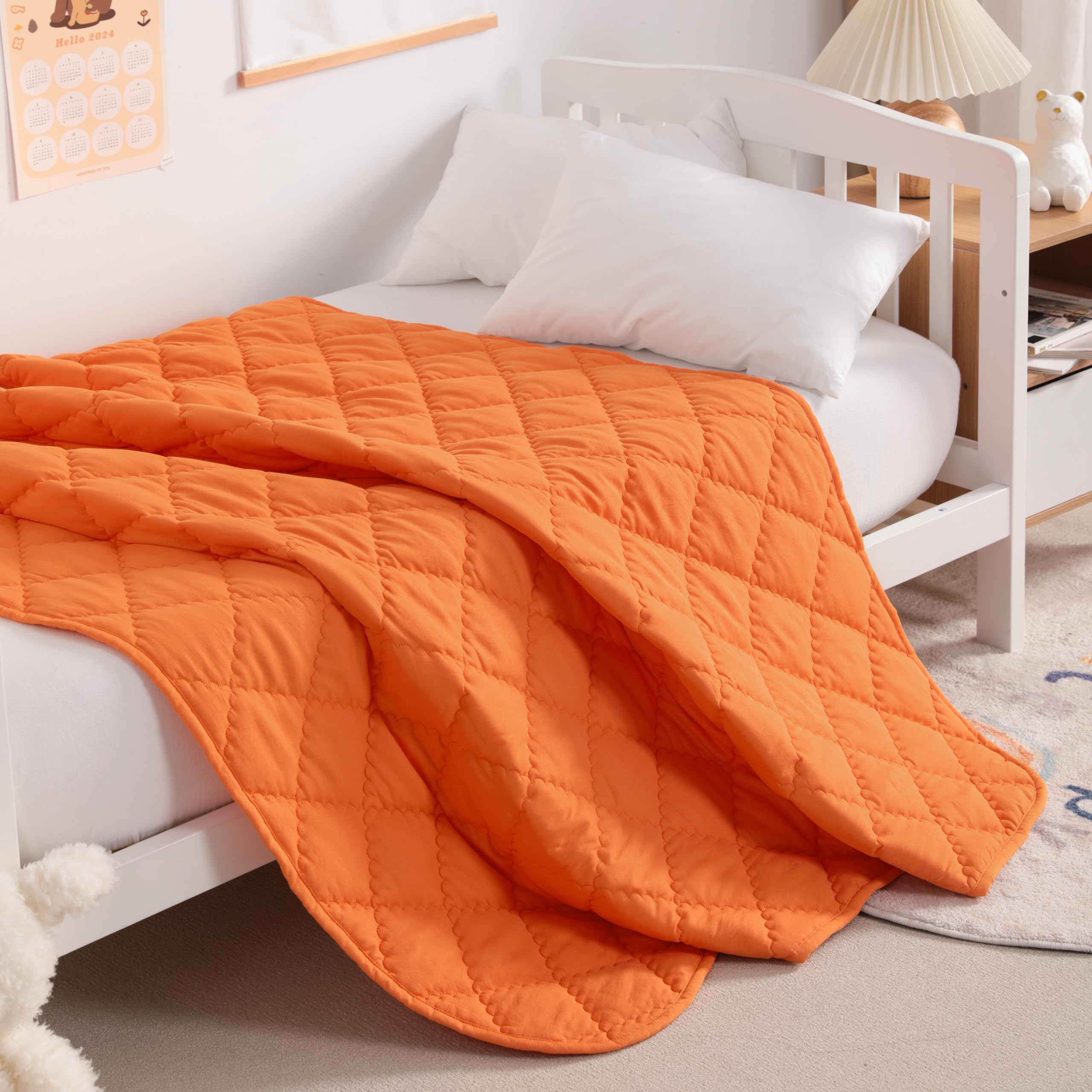 NTBAY orange toddler quilt laid on a bed, showcasing year-round soft warmth