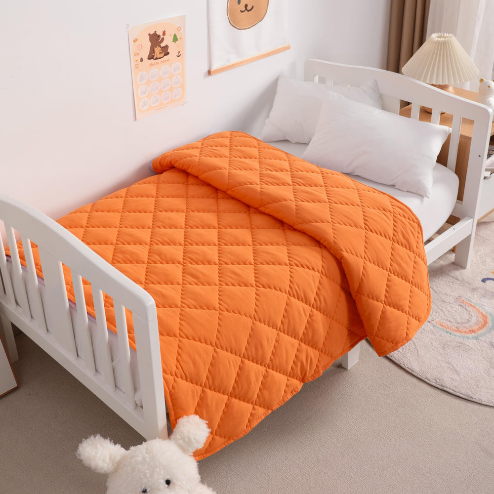 NTBAY orange quilt folded for travel, lightweight and cozy