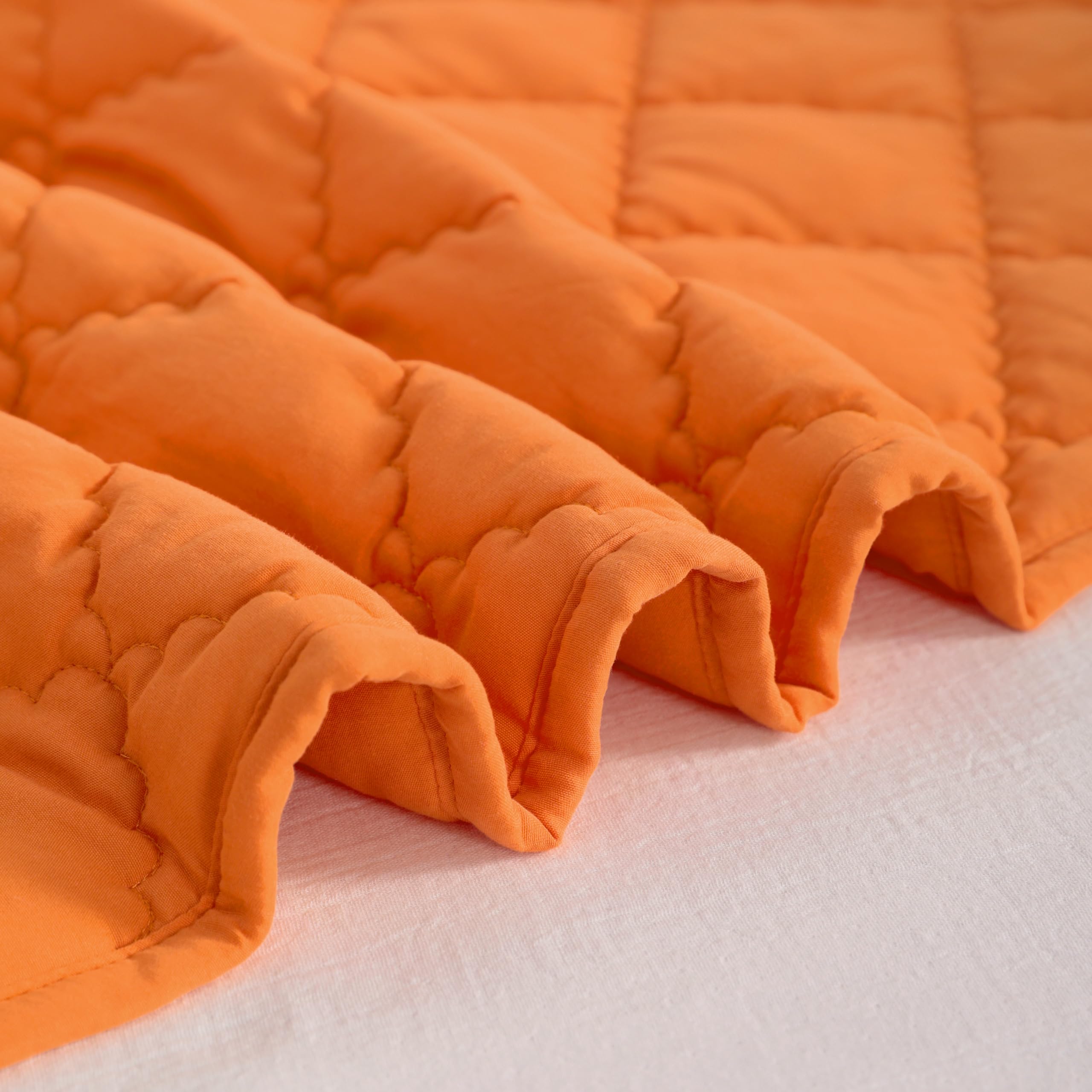 NTBAY orange quilt demonstrating easy-care fabric for busy households