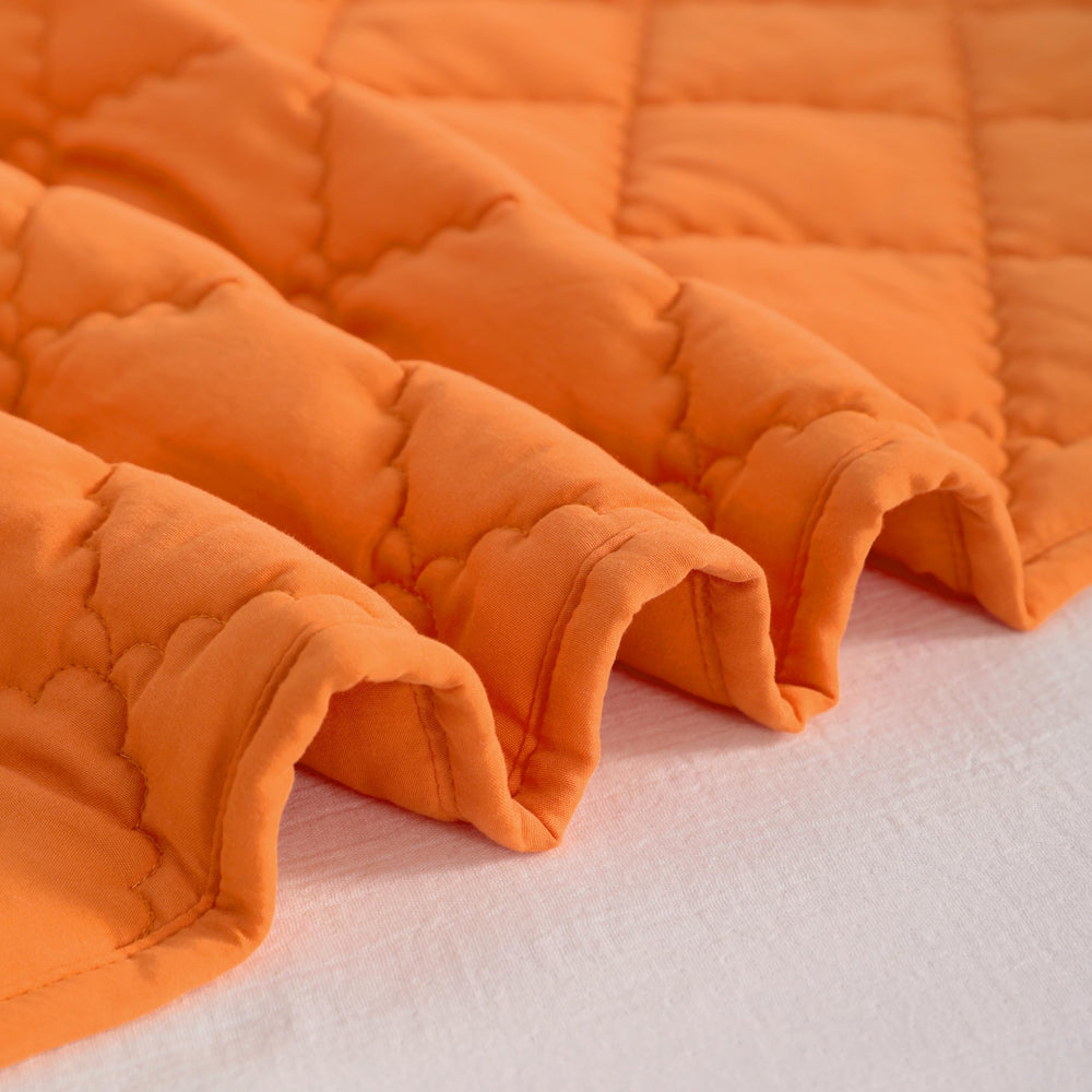 NTBAY orange quilt demonstrating easy-care fabric for busy households