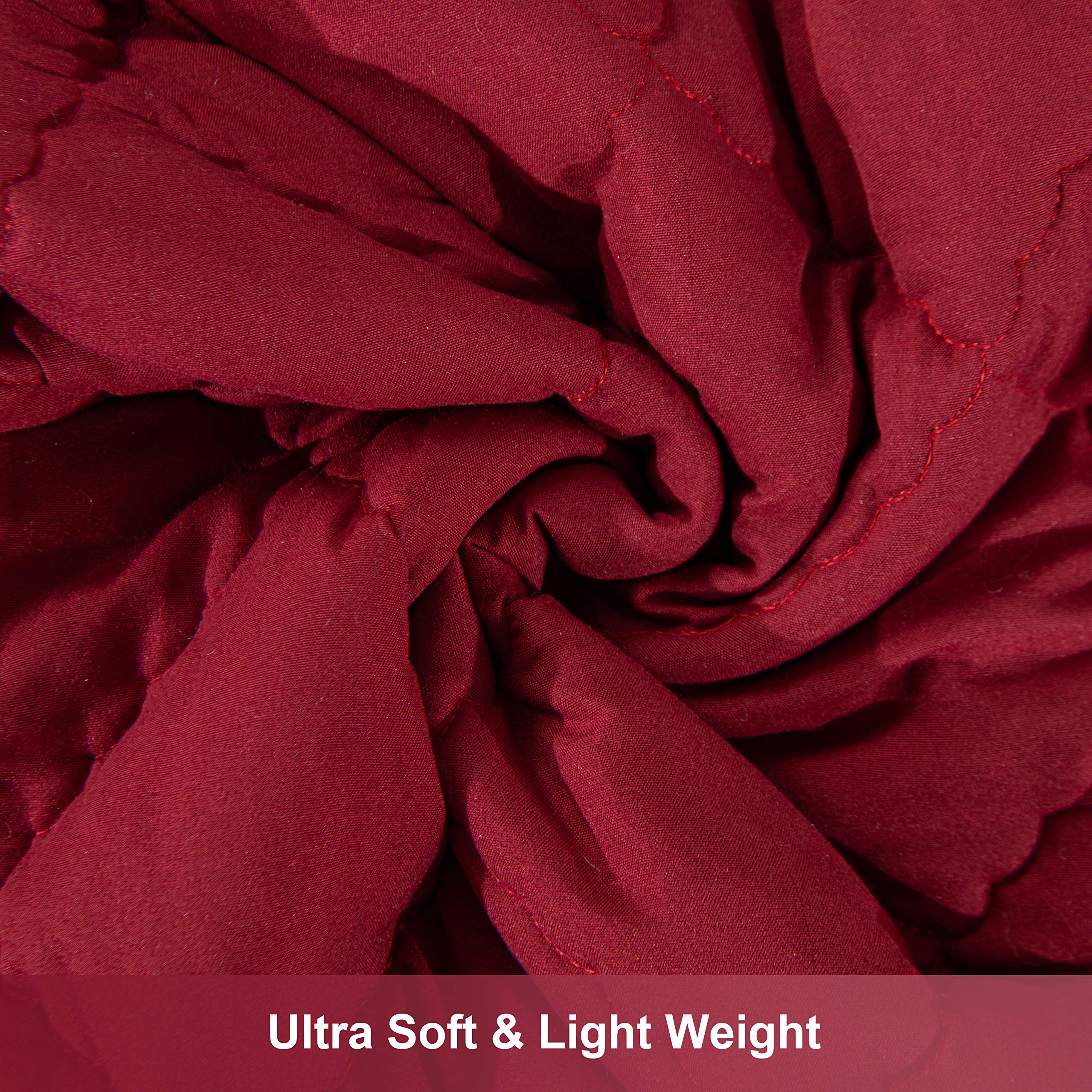 NTBAY Down Alternative Toddler Comforter red microfiber texture close-up emphasizes softness.