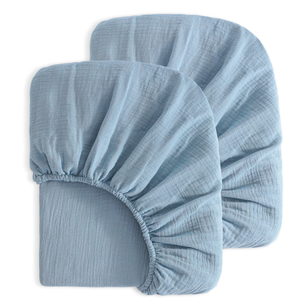 NTBAY mini crib sheets in sky blue provide a soft, breathable surface for naps.