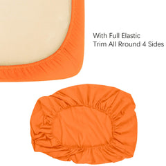 NTBAY orange crib sheet folded for storage and quick change.