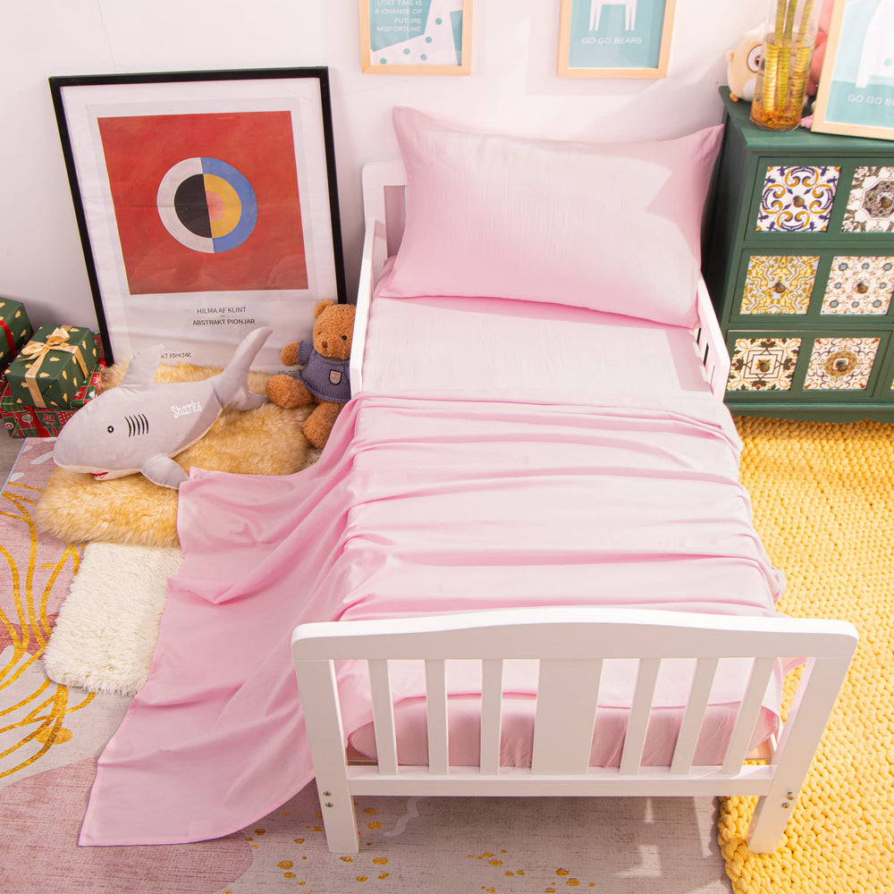 NTBAY nursery setup with pink bedding promotes a calm sleeping space.